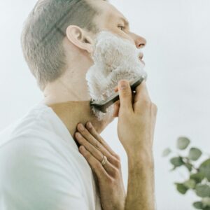 man shaving his beard